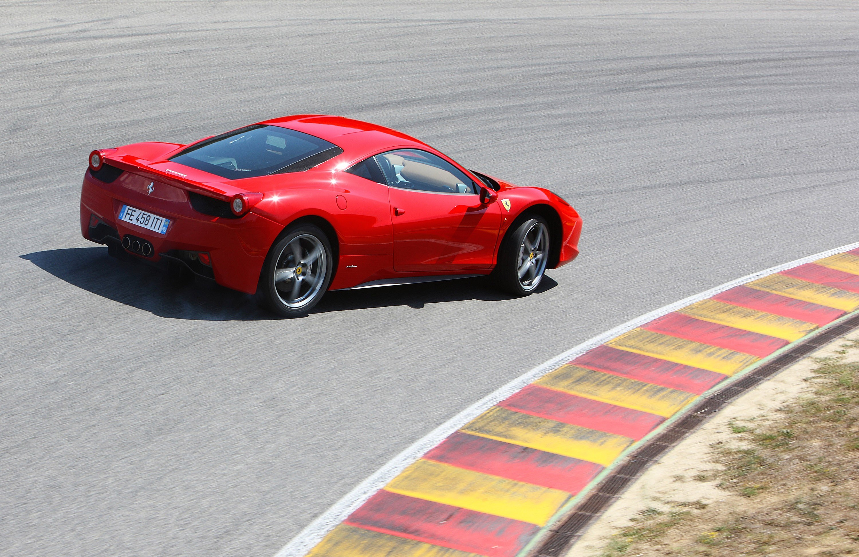 Red Ferrari on racetrack