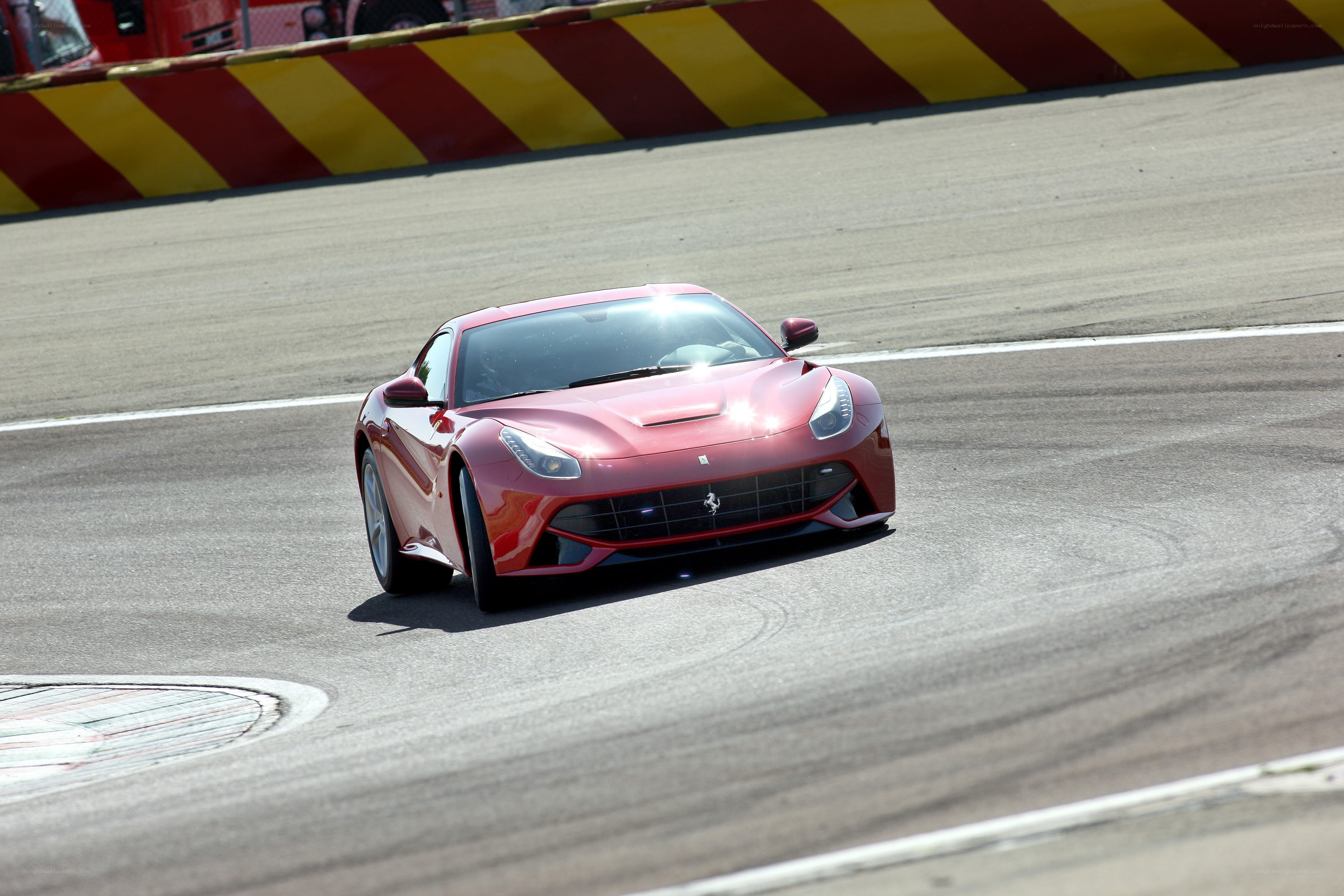 Red Ferrari on racetrack