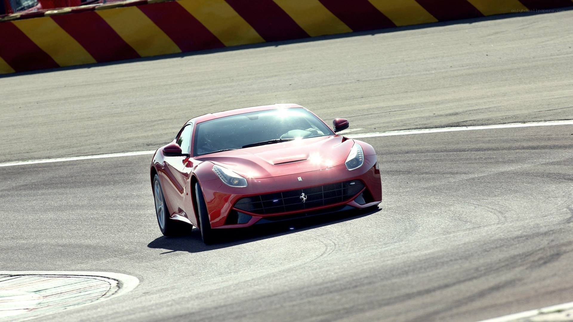 red ferrari on racetrack