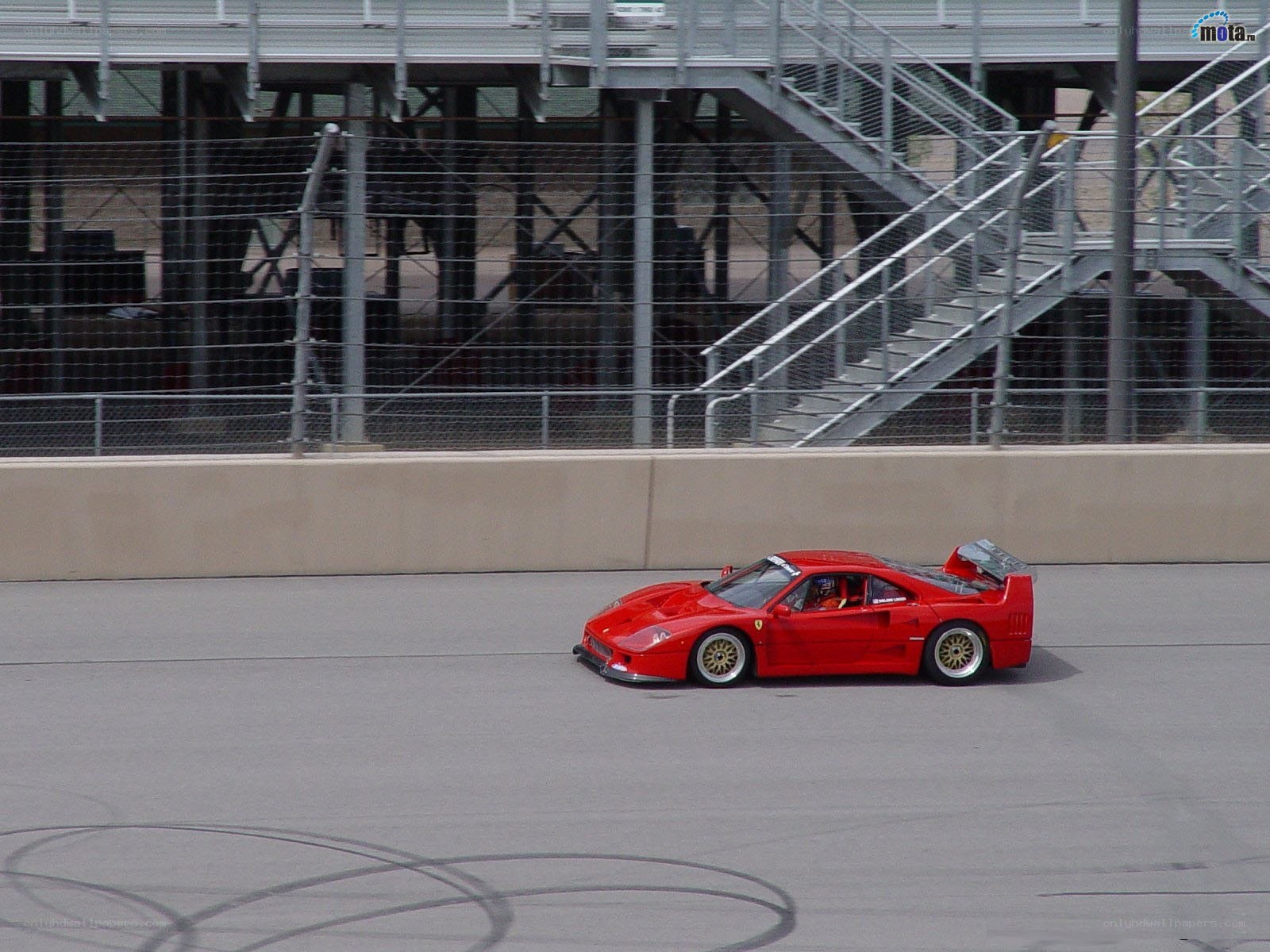 Red Ferrari on racetrack