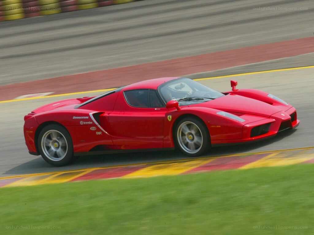 red ferrari on racetrack
