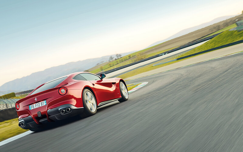 Red Ferrari on Racetrack — Dynamic, Afternoon