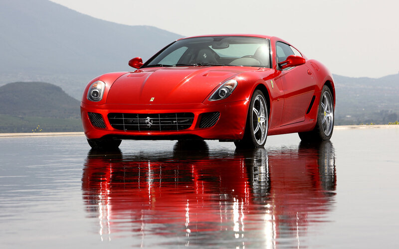 Red Ferrari on reflective surface