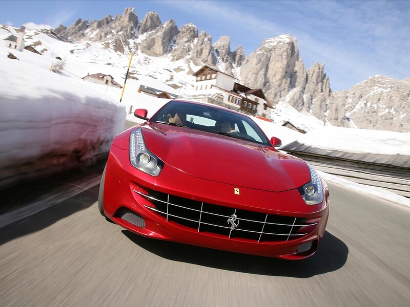 Red Ferrari on snowy mountain road