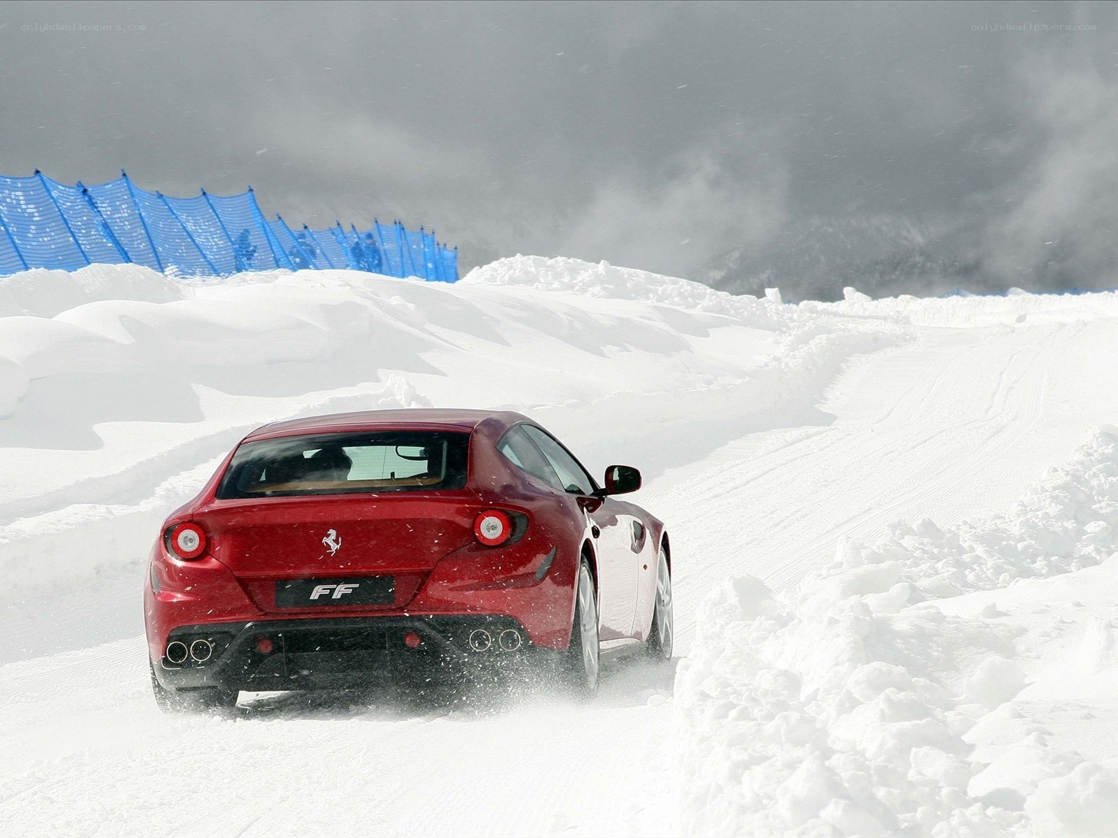 Red Ferrari on snowy track