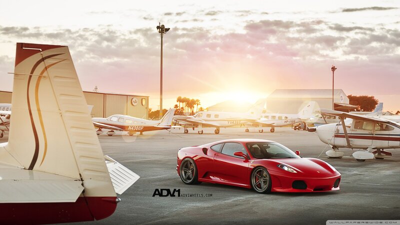 Red Ferrari on Tarmac — Dramatic