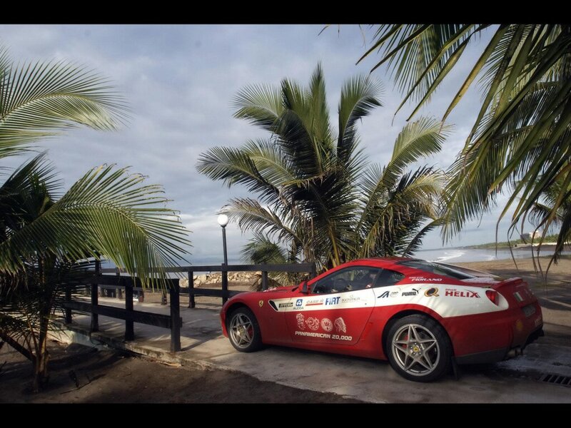 Red Ferrari on tropical beach