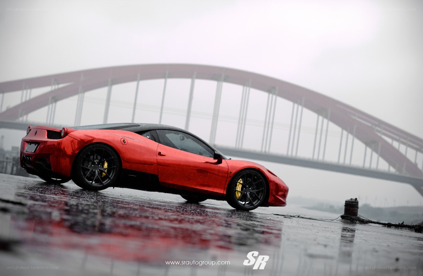 Red Ferrari on wet pavement