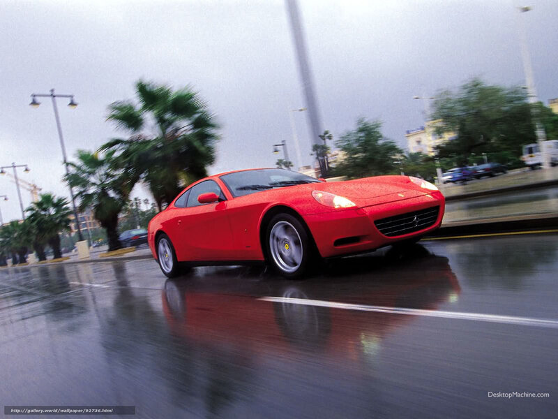 Red Ferrari on wet road