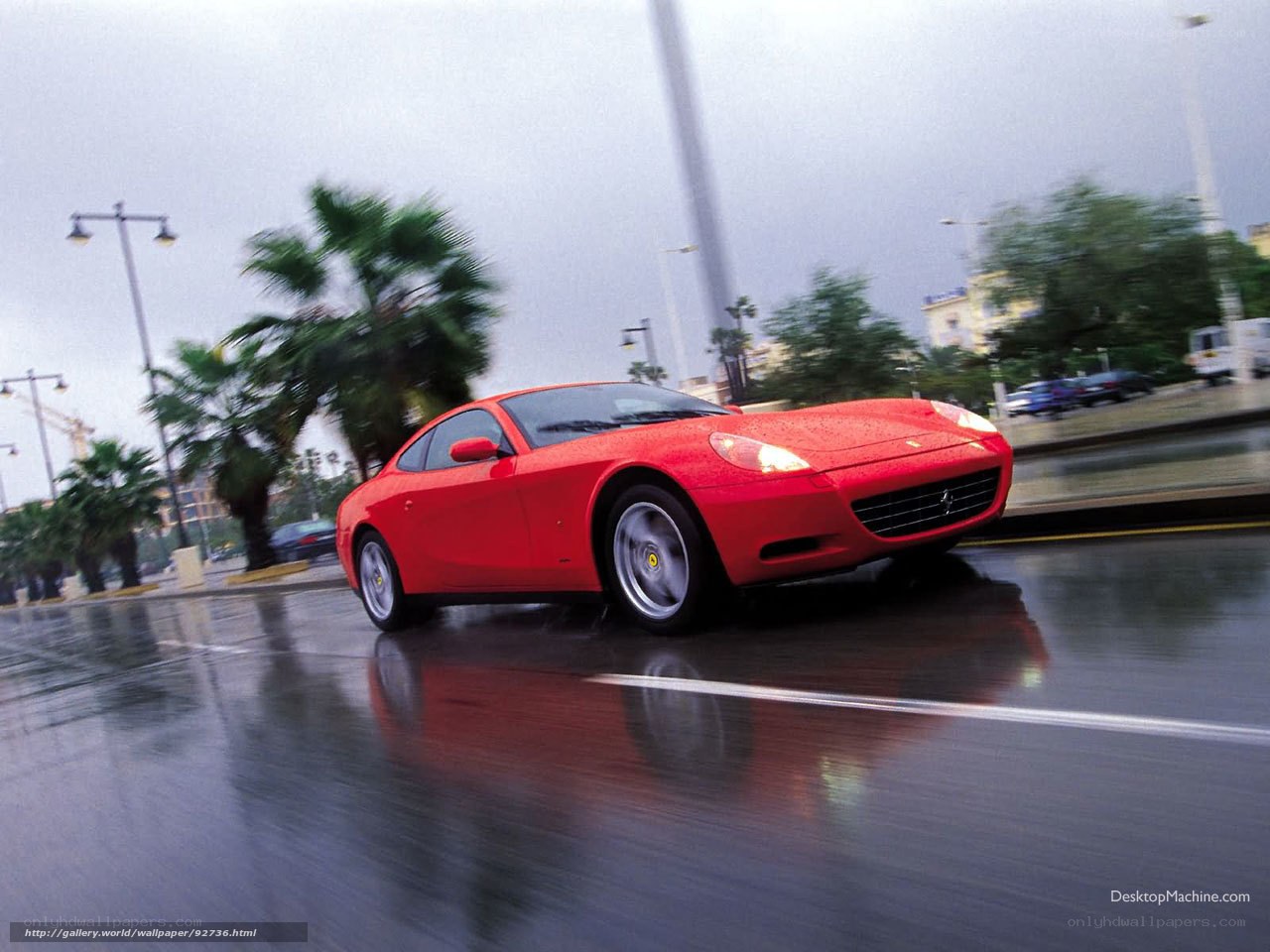 Red Ferrari on wet road