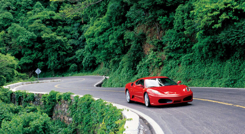Red Ferrari on winding road