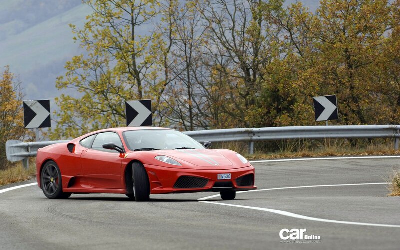 Red Ferrari on winding road