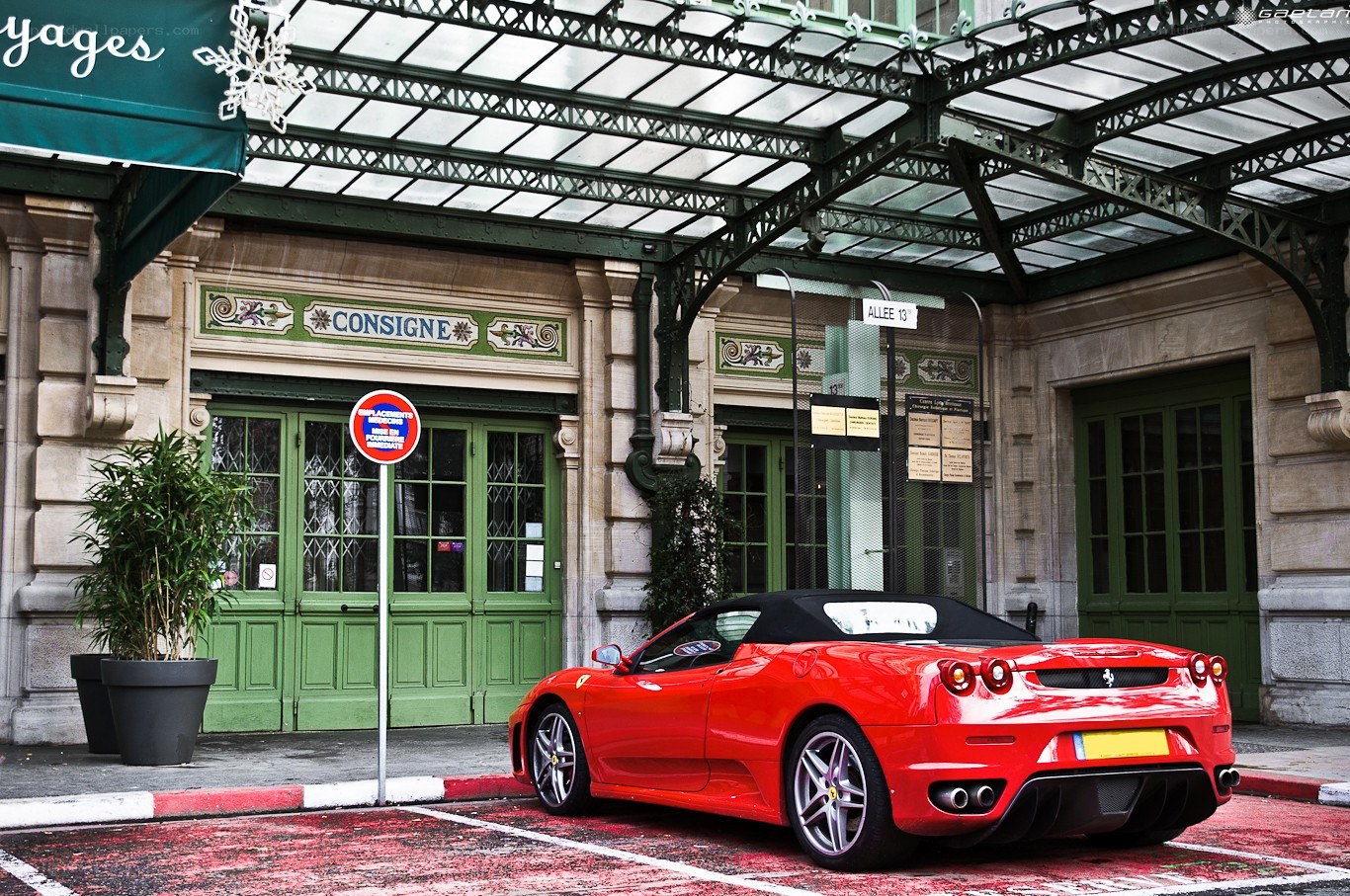 Red Ferrari parked at hotel
