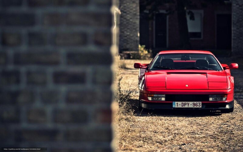 Red Ferrari parked in alley