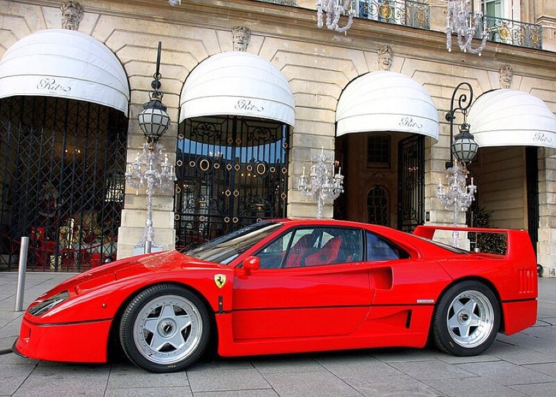 Red Ferrari parked in front of a building