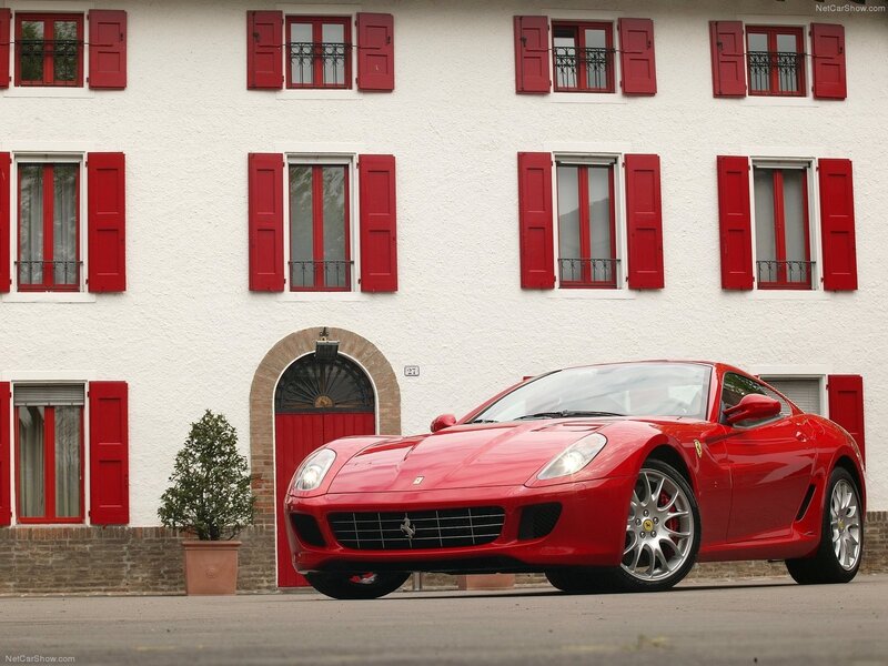 Red Ferrari parked in front of building