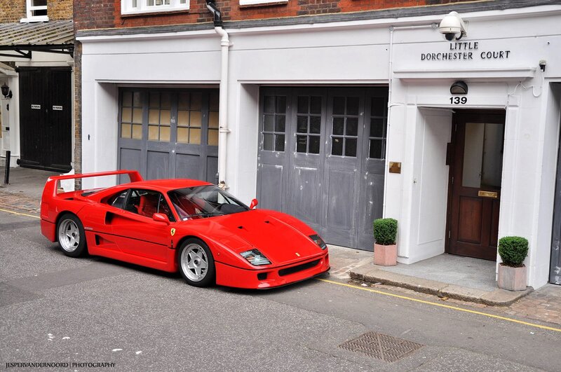 Red Ferrari parked on street