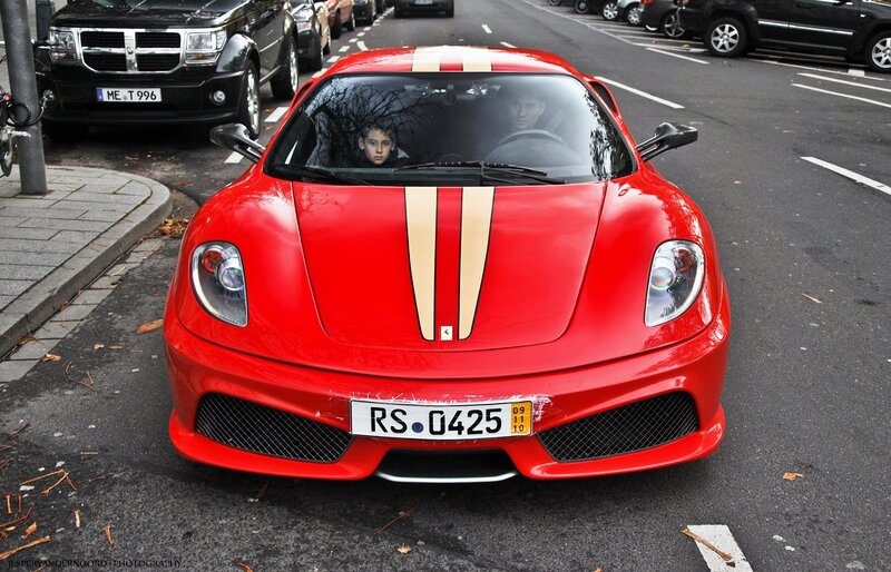 Red Ferrari parked on street