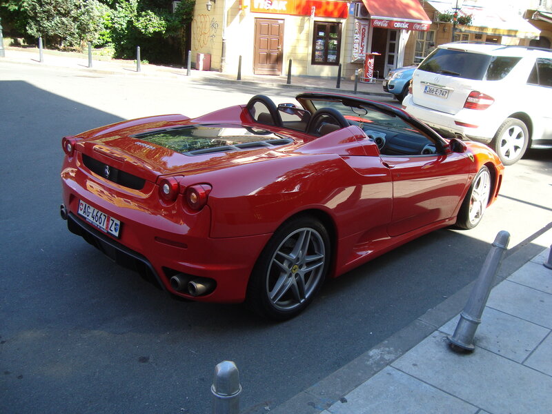 Red Ferrari parked on street