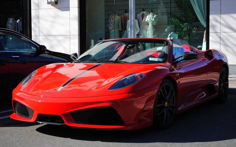 Red Ferrari parked on street