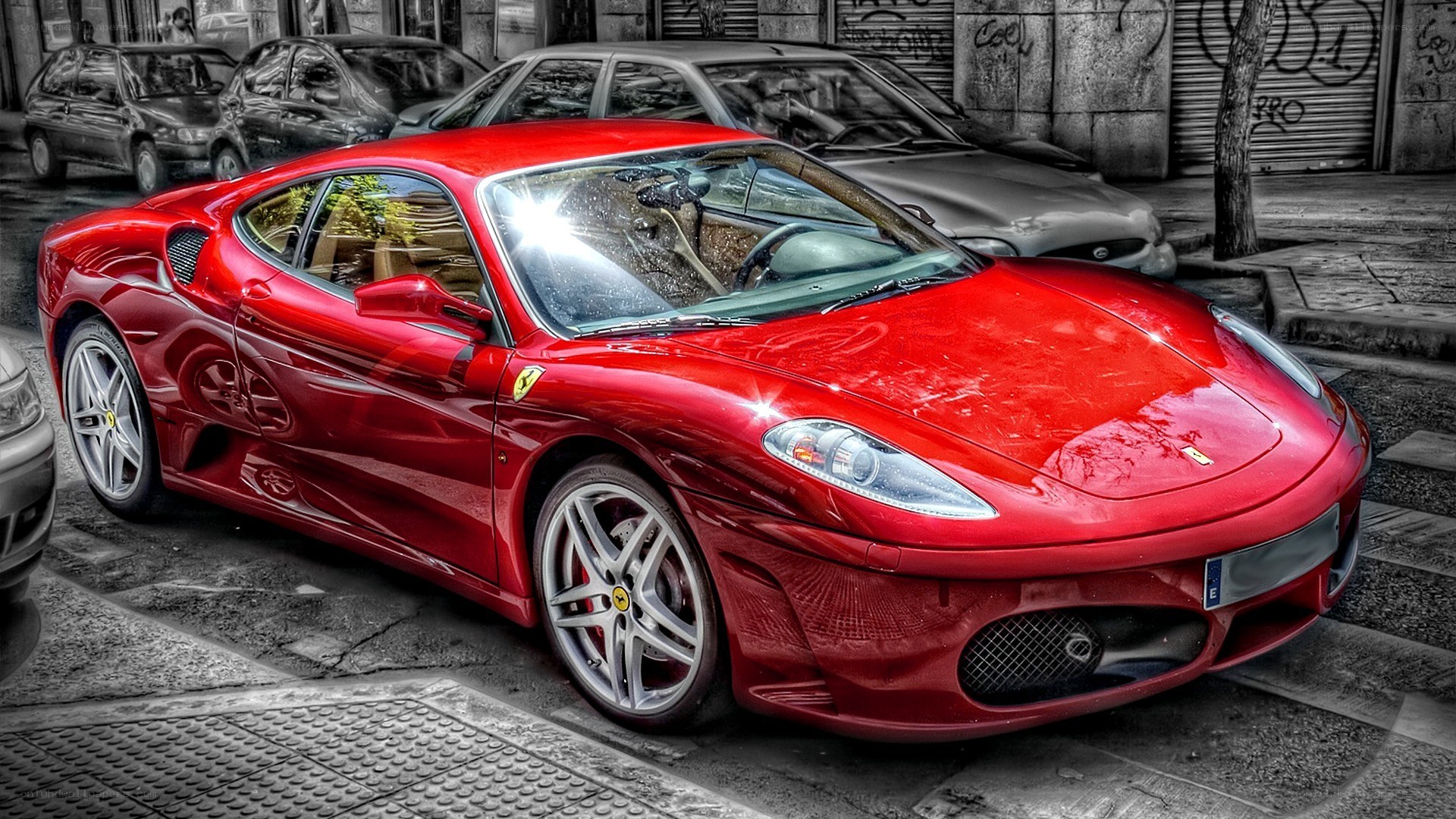 Red Ferrari parked on street