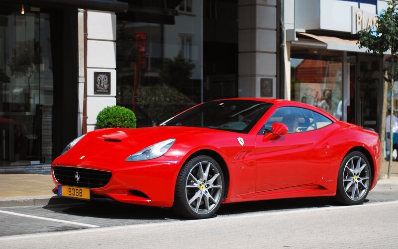 Red Ferrari parked on street