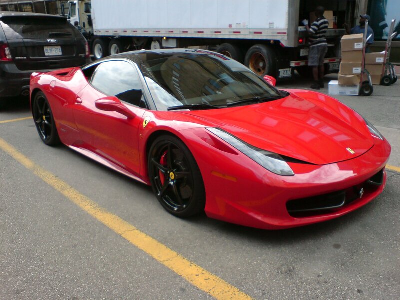 Red Ferrari parked on street