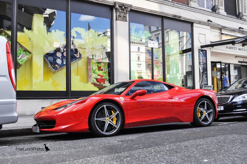 Red Ferrari parked on street