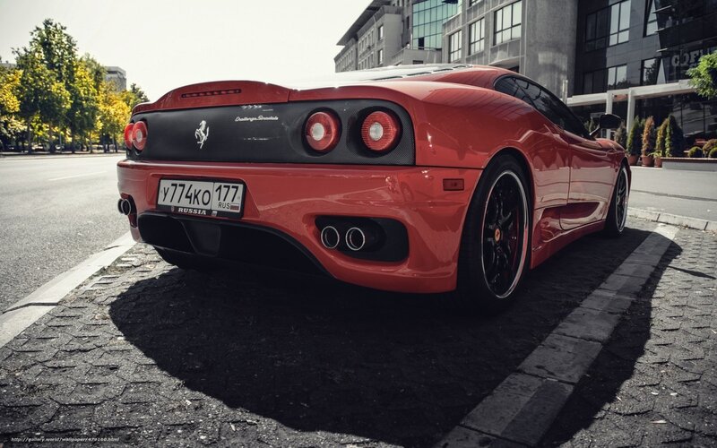 Red Ferrari parked on street