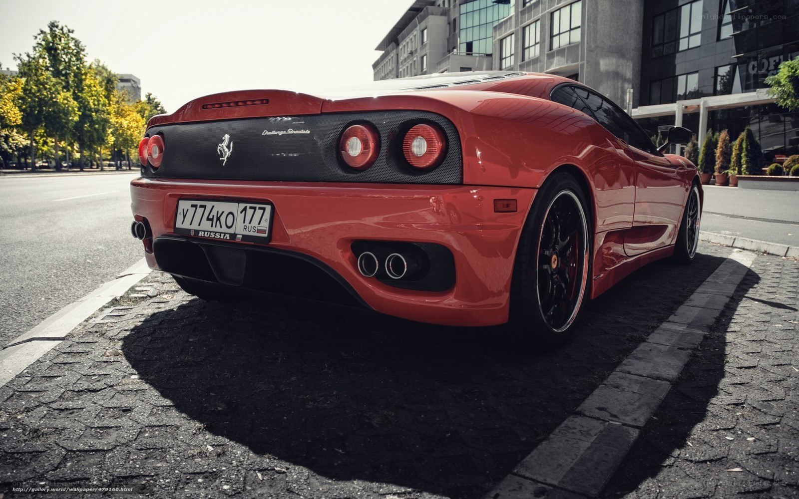 Red Ferrari parked on street