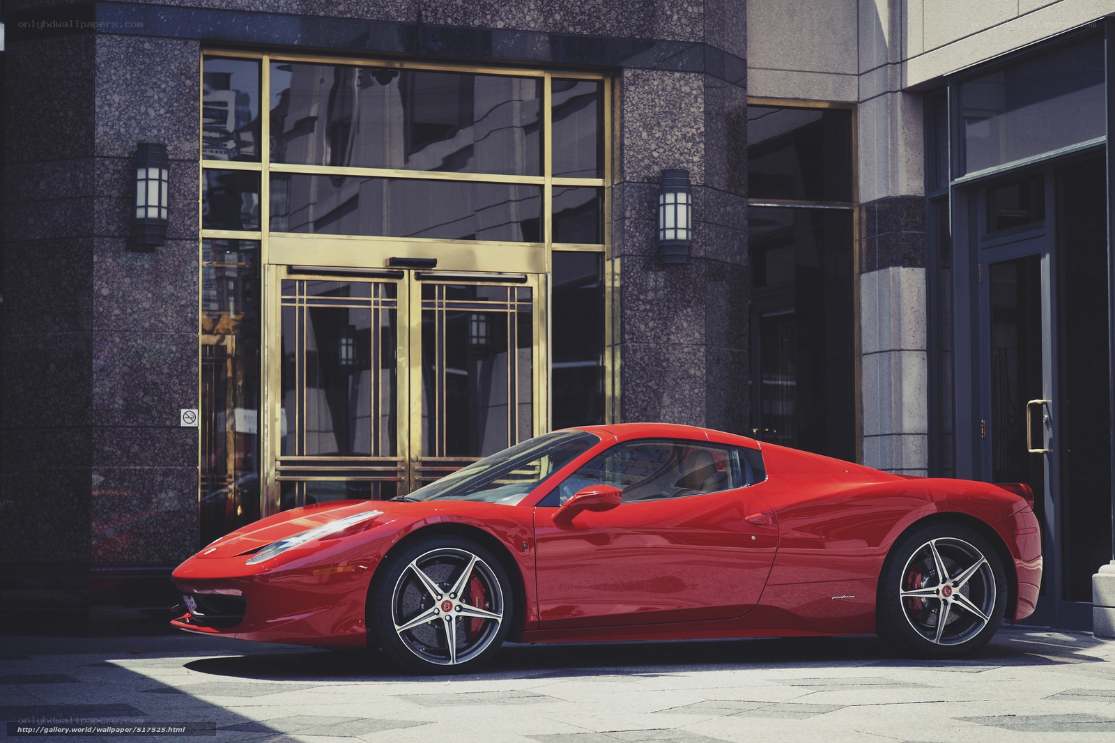 Red Ferrari parked outside building