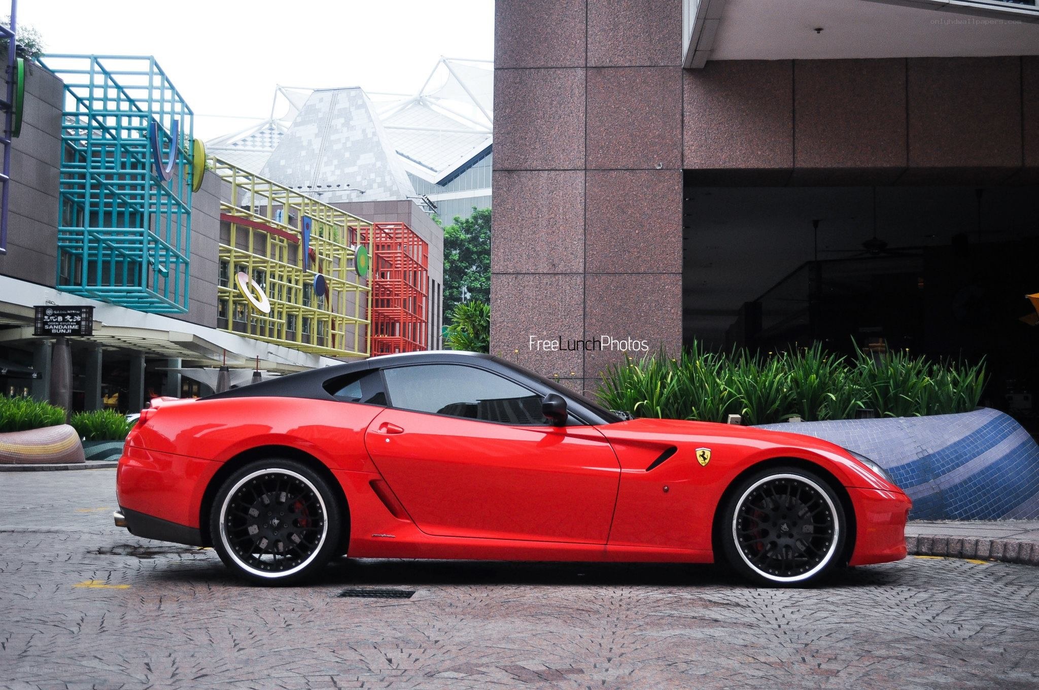 Red Ferrari parked outside building