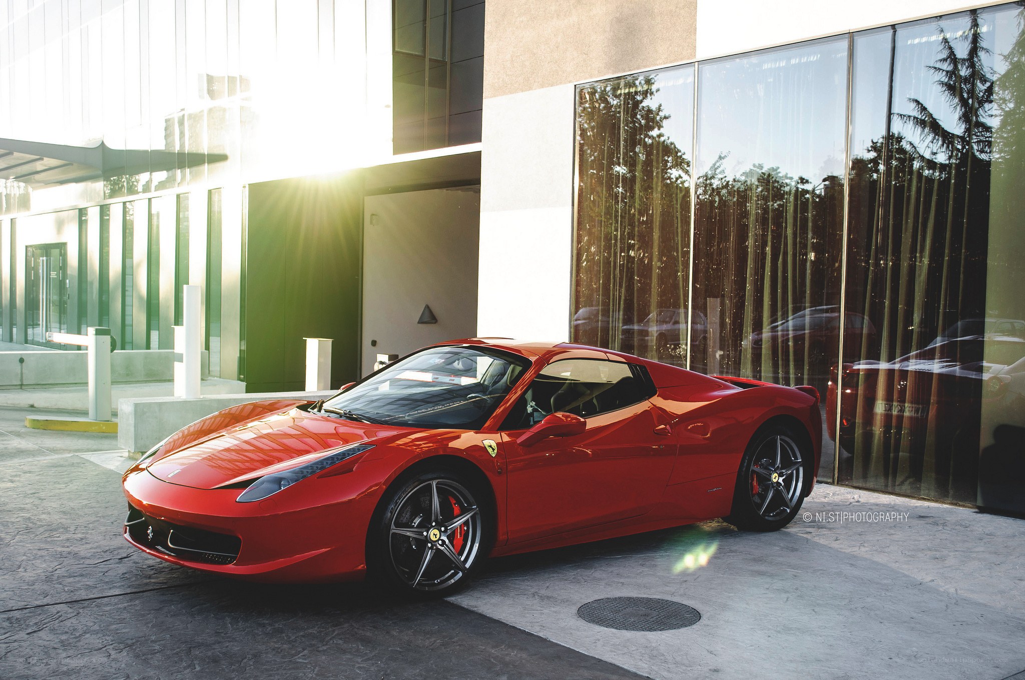 Red Ferrari parked outside building