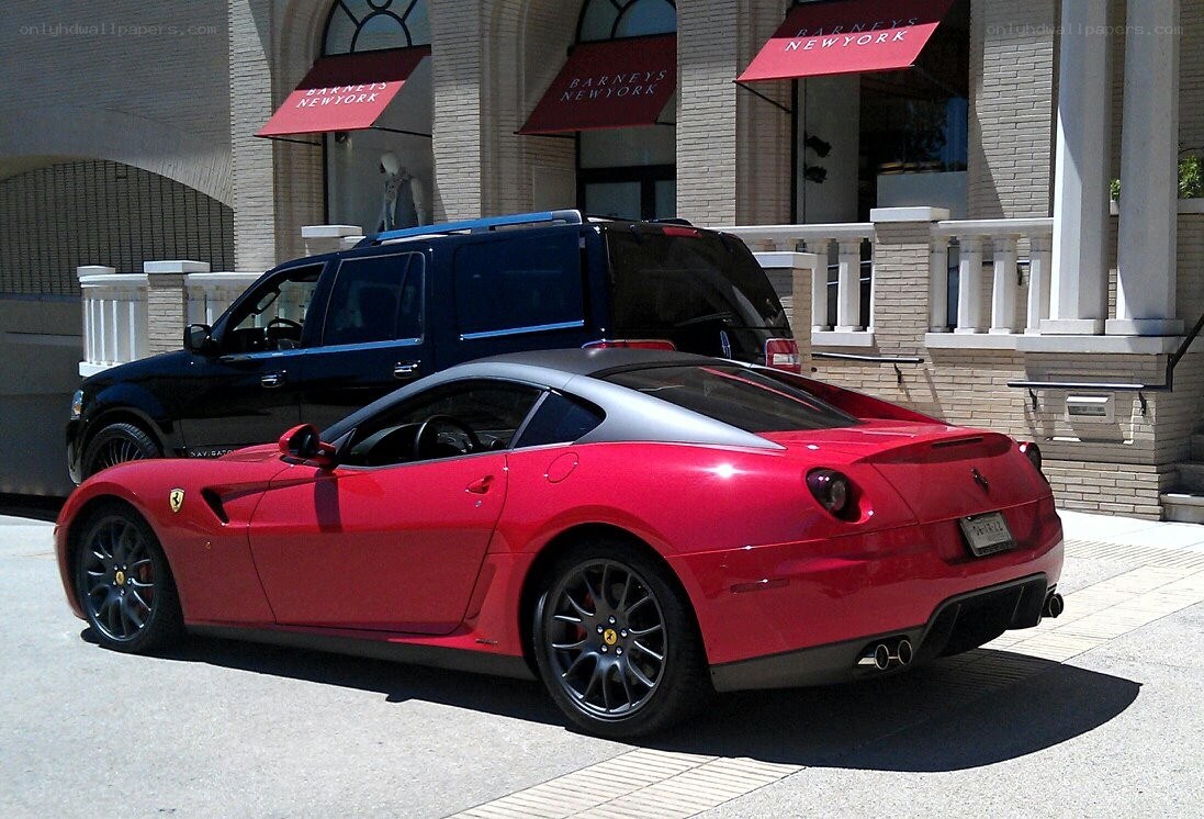 Red Ferrari parked outside store