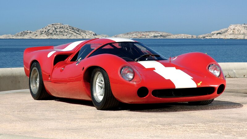 Red Ferrari race car by the sea