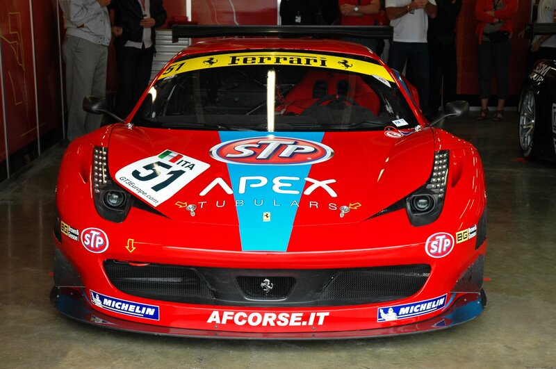Red Ferrari race car in garage