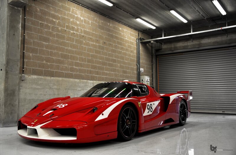 Red Ferrari race car in garage
