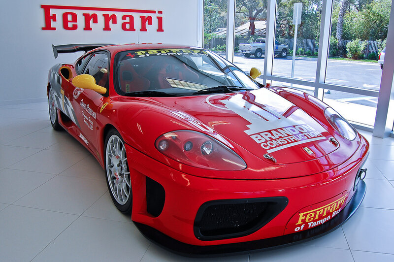Red Ferrari race car in showroom