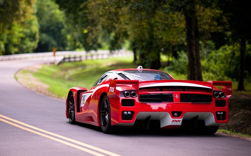 Red Ferrari race car on a road