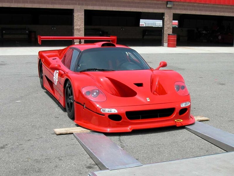 Red Ferrari race car on lift