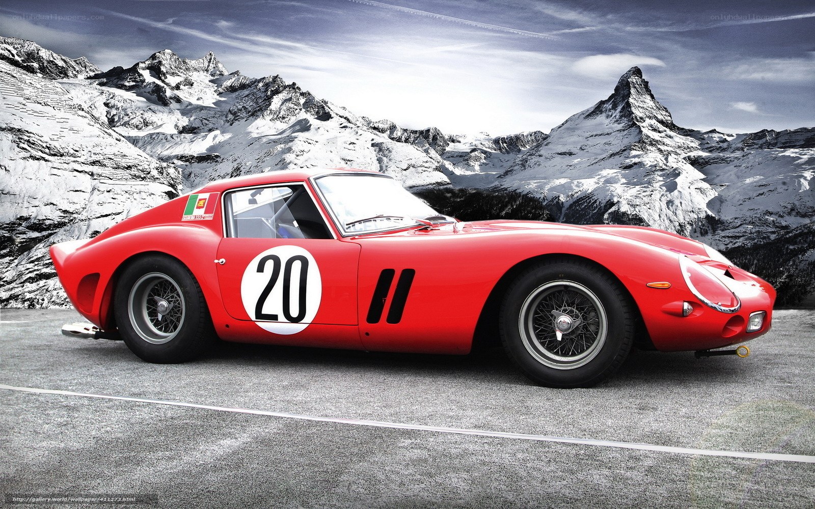 Red Ferrari race car on mountain road