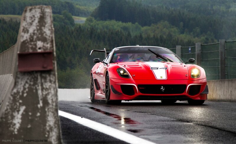 Red Ferrari race car on wet track