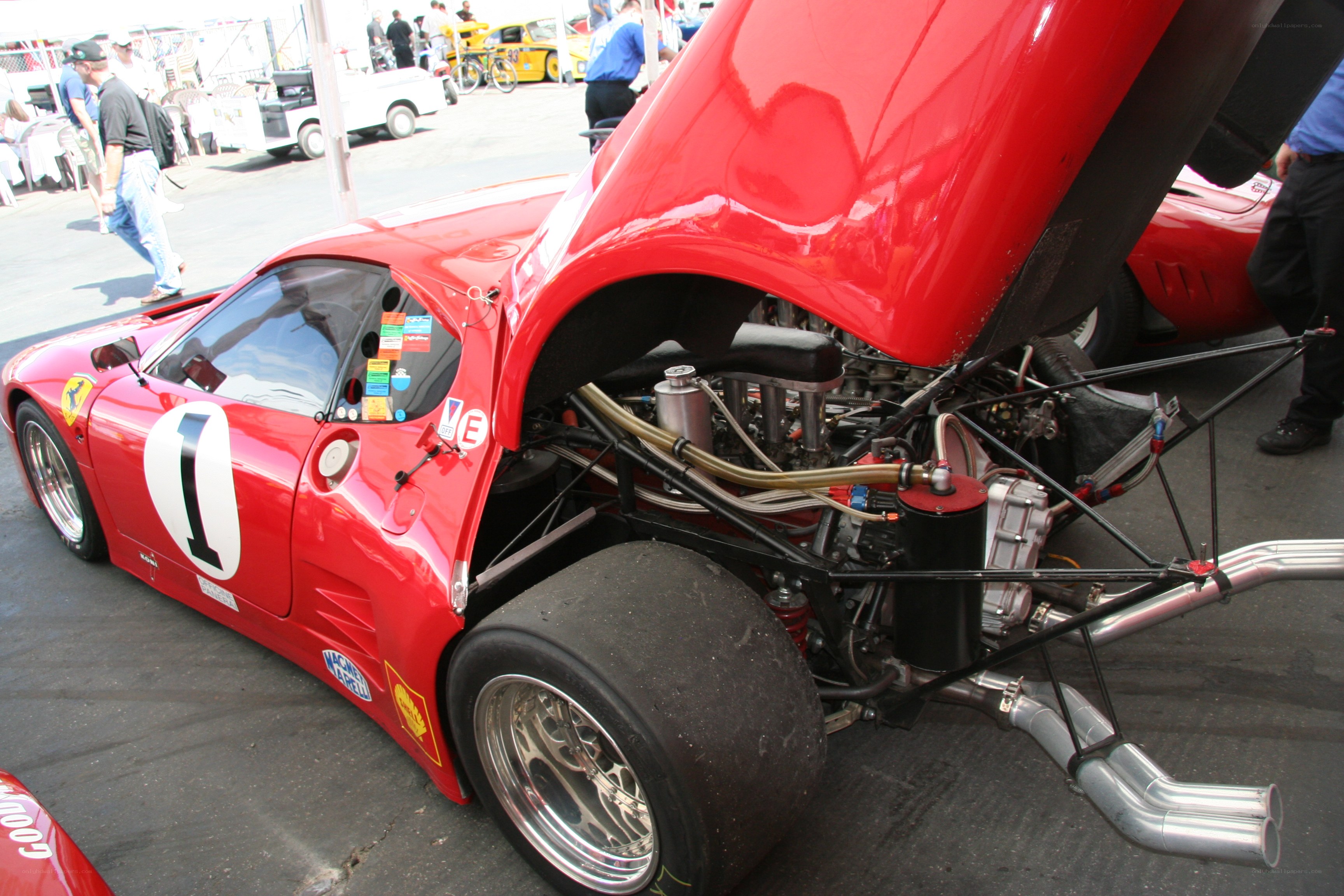 Red Ferrari race car with open engine