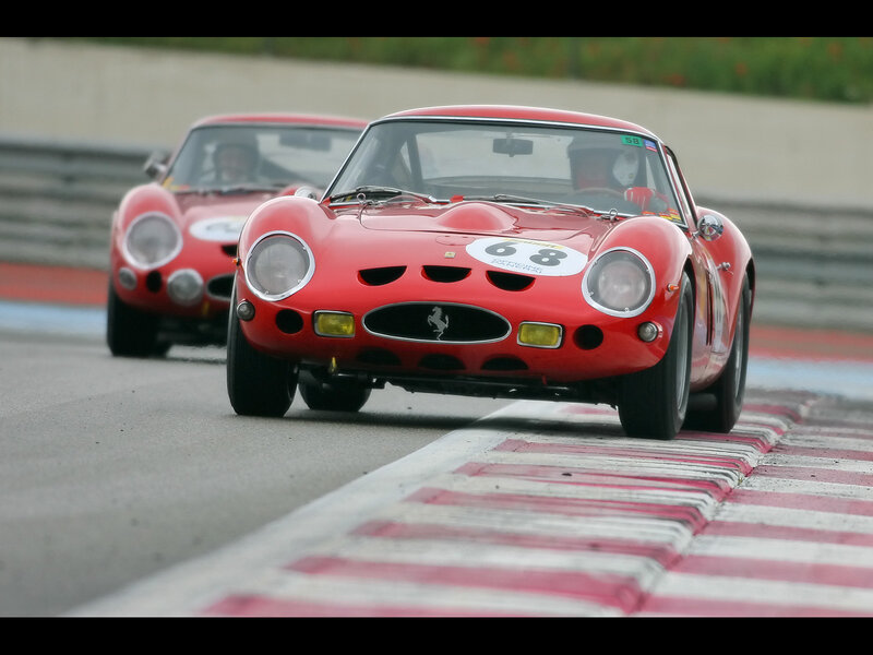 Red Ferrari race cars on track