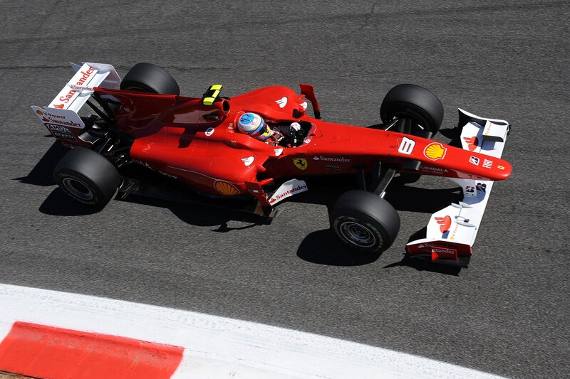 Red Ferrari racing car on track