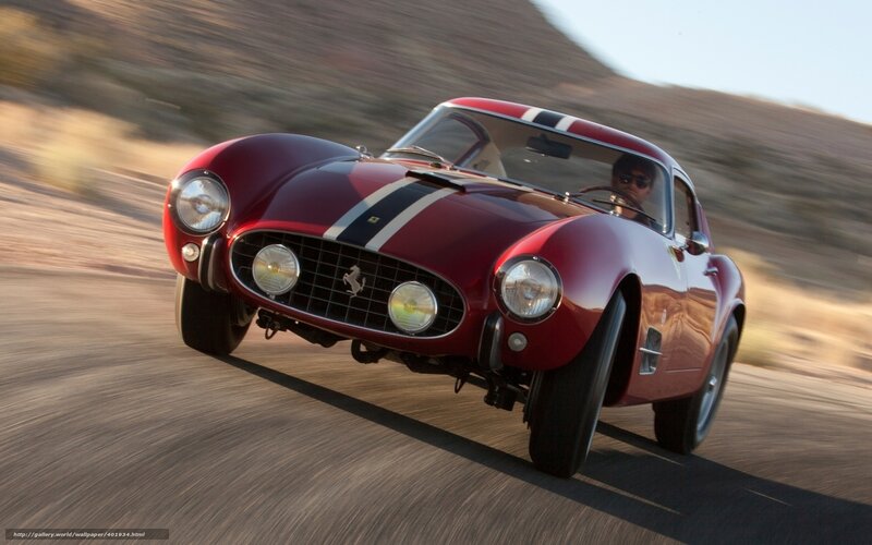 Red Ferrari racing on desert road