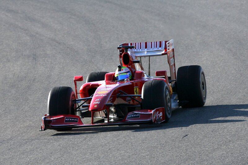 Red Ferrari racing on track