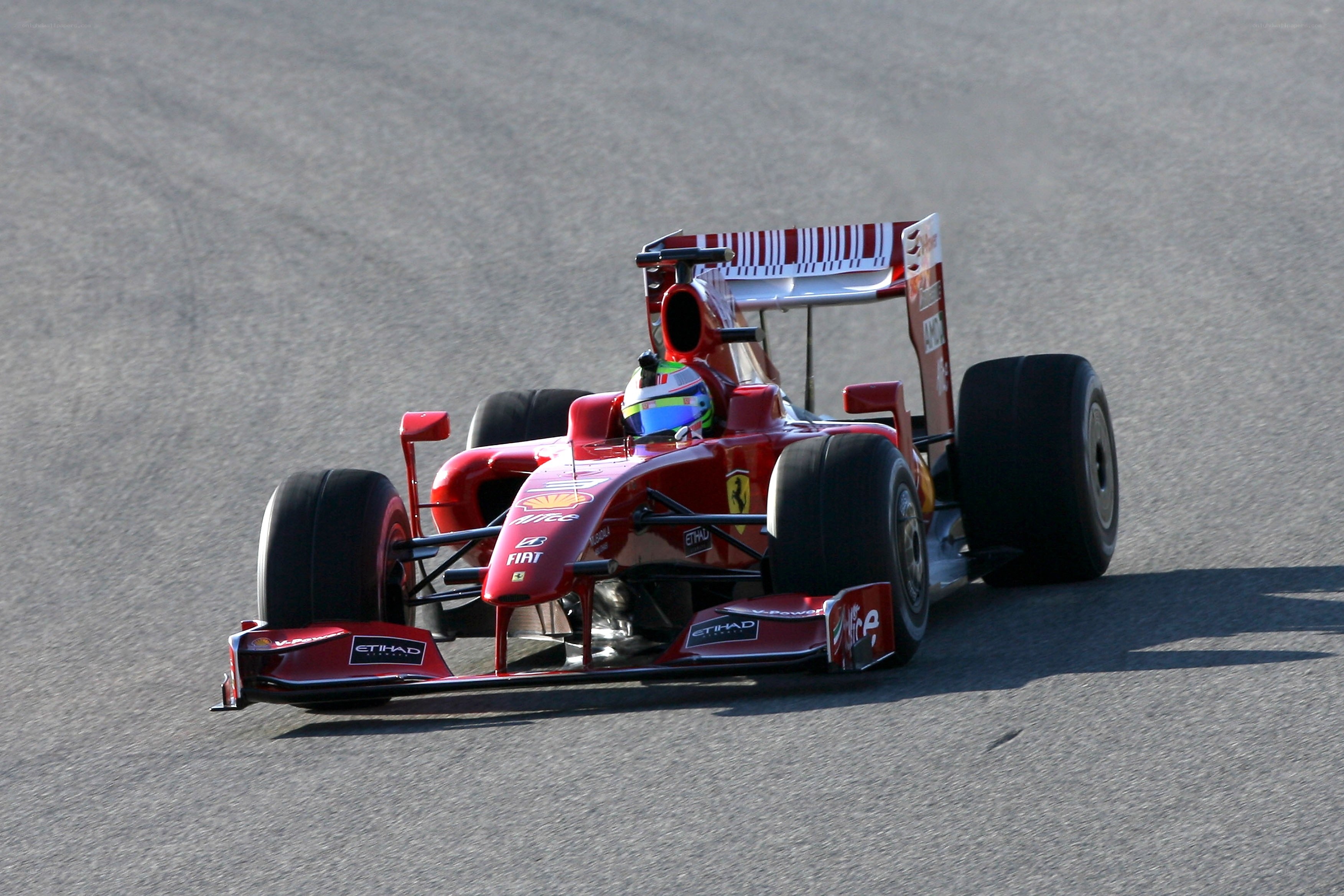 Red Ferrari racing on track