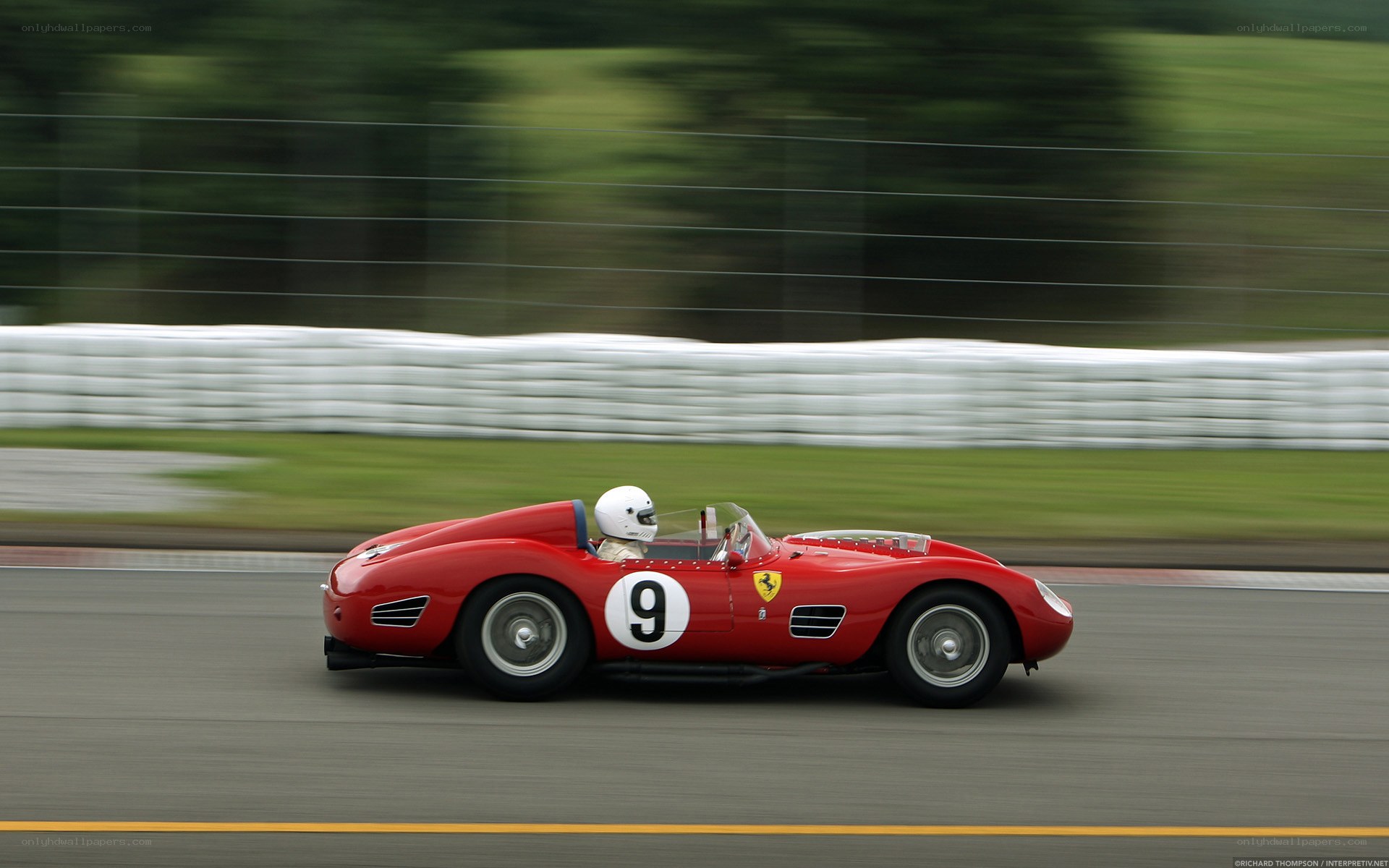 Red Ferrari racing on track