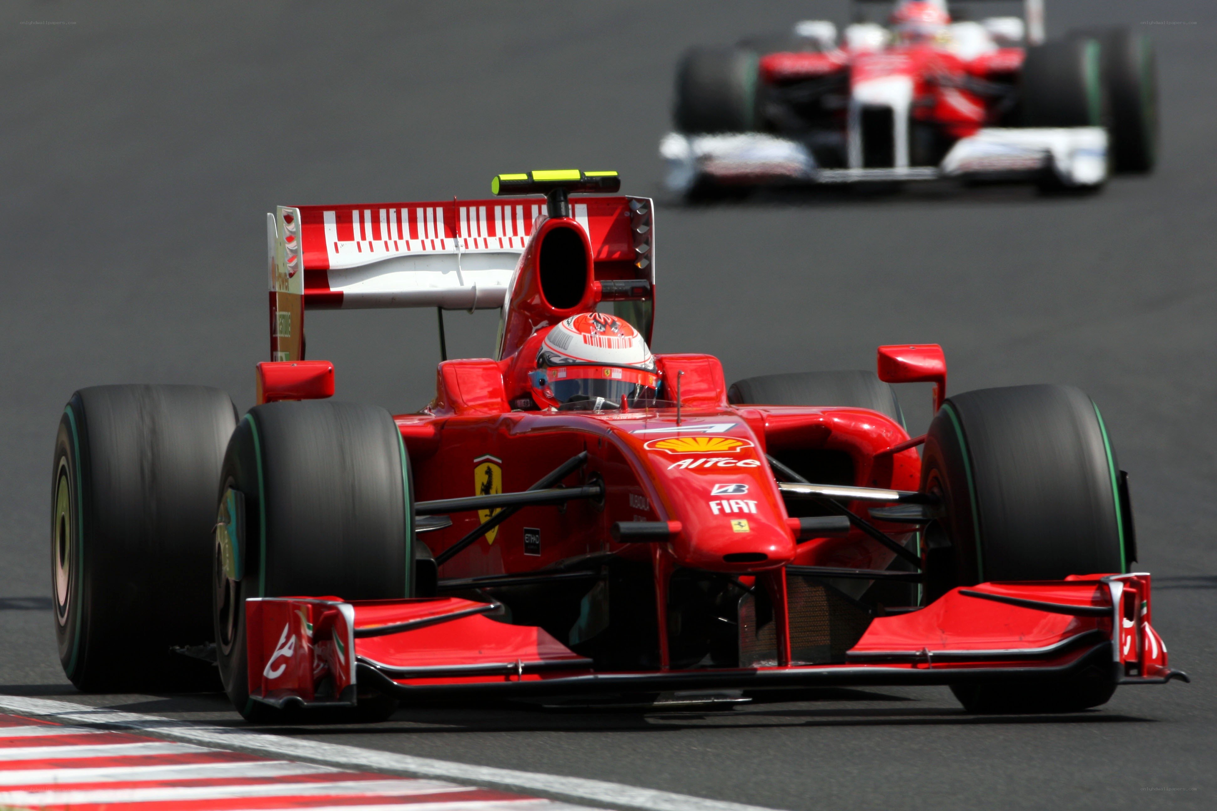 Red Ferrari racing on track